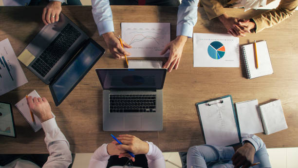 istock Business people reviewing project reports during a corporate meeting 1368649259