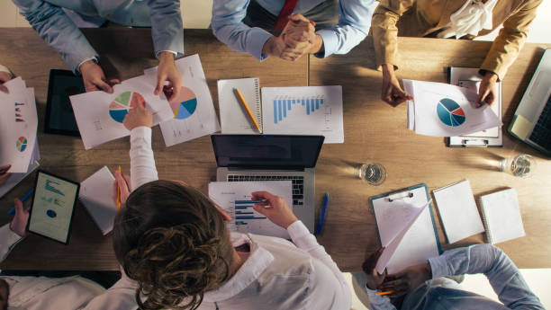 istock Businesswoman pointing to data on a pie chart during a corporate meeting 1368649272
