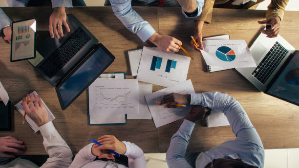 istock Business colleagues discussing graphs and charts they are reviewing on documents 1368649279