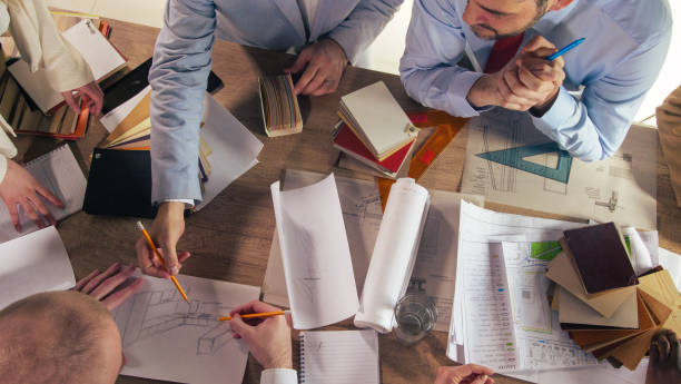 istock Team of creative interior designs assisting their colleague in drawing a sketch 1368650252