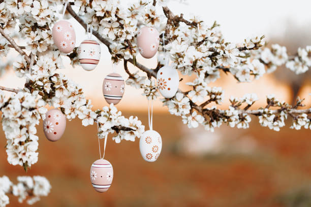 istock Boho easter eggs in beige and brown tones hanging in between almond blossoms on an almond tree 1368650317