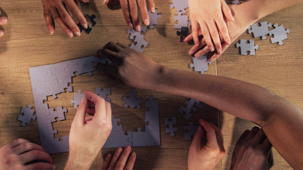 istock Unrecognizable friends passing time by assembling a jigsaw puzzle together 1368650580