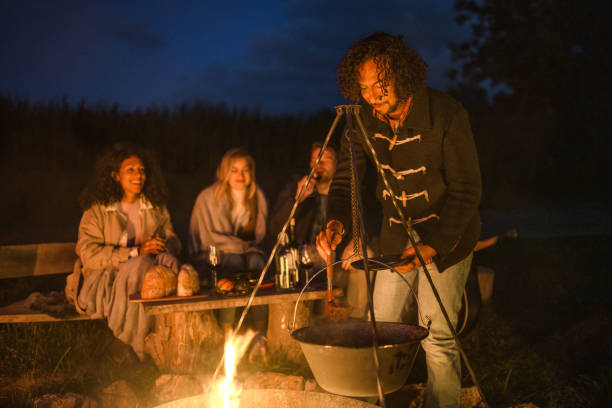 istock Mixed Race Friends Camping Together In Nature 1368650763