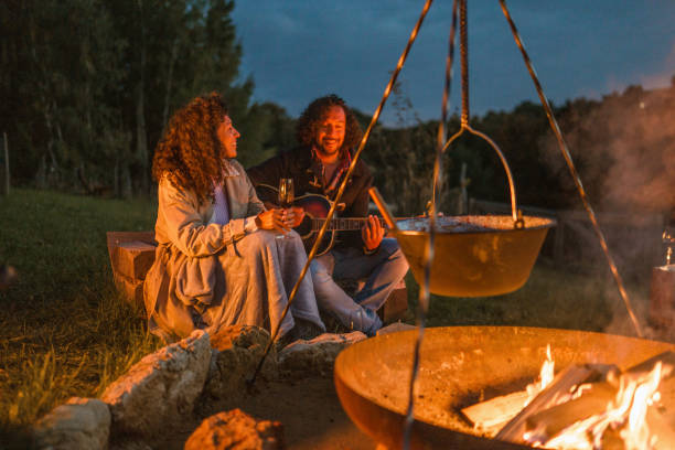 istock Mature Hispanic Couple Enjoying Their Meal Next To A Capmfire 1368650779