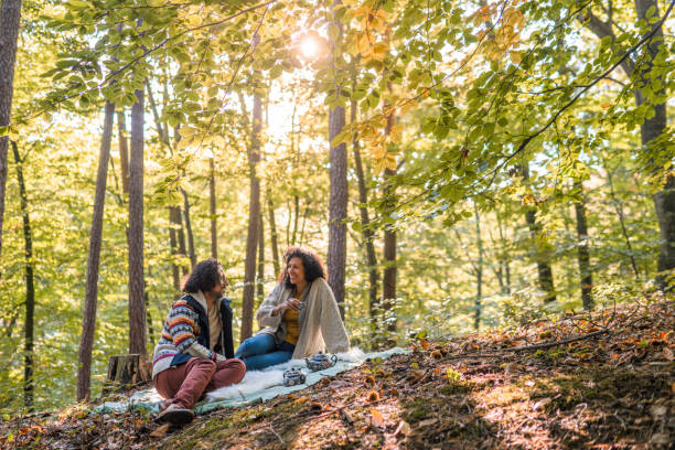 istock Hispanic Couple Having Tea Time In The Woods 1368650810