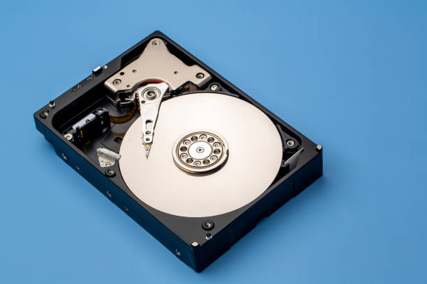 istock Hard disk drive and open cover. Computer hardware, hard disk, storage device. Detail of the inside of a hard disk drive. Hard disk is internal mechanism hardware 1368653807