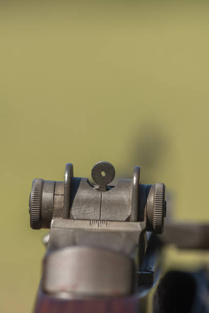 Macro of rifle sights with greenery out of focus in the background. Photo taken in High Springs, Florida. Nikon D750 with Nikon 200mm macro lens.