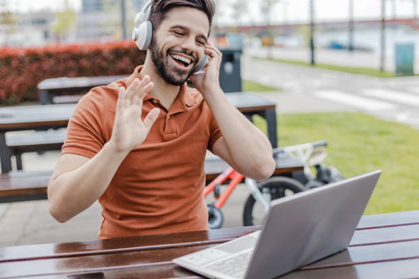 istock Young man using laptop and talking with someone on a video call 1368656353