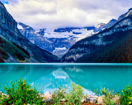 Glacier fed Rocky Mountain lake in Banff National Park surrounded by high peaks, Alberta, Canada