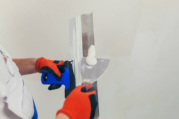 istock A man hands worker plasters the wall with a spatula and applies a cement mix solution. The repairman lays the plaster on the drywall. Close-up 1368660003