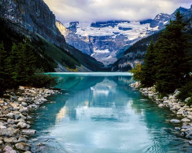 Glacier fed Rocky Mountain lake in Banff National Park surrounded by high peaks, Alberta, Canada