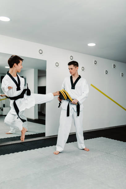 istock Disabled woman training taekwondo with her coach. 1368661883
