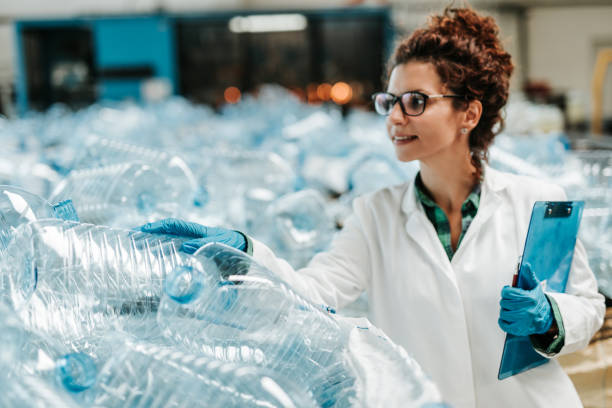 Bottling plant Young happy female worker in bottling factory recycling department. Inspection quality control. recycling center stock pictures, royalty-free photos & images