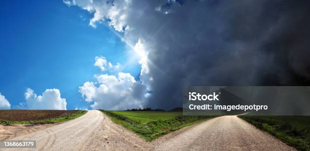 Empty Forked Road Over Conceptual Dramatic Sky Stock Photo - Download Image Now - Forked Road, Storm Cloud, Separation