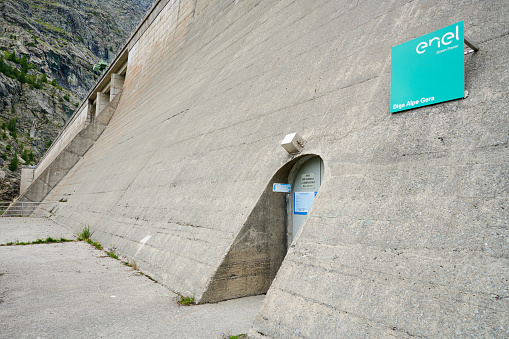 Lanzada, Italy - July 17, 2021: a sign at the base of the cementa dam wall of Alpe Gera Dam. Malenco Valley. Lombardy.