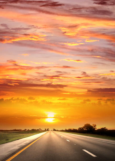 istock Empty asphalt road over romantic orange color sunset sky 1368663222