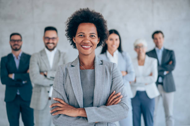 istock Confident businesswoman and her team. 1368665441