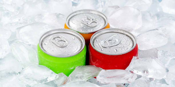 istock Drinks lemonade cola drink softdrinks in cans with ice cubes panorama 1368666135