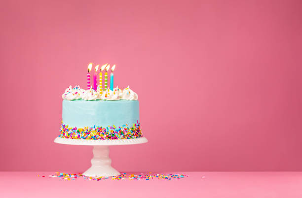 Blue Birthday Cake with Five Candles over Pink Background