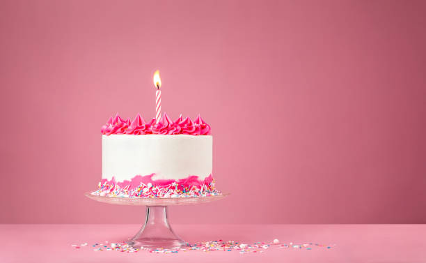 istock Pink Birthday Cake with Candle on pink background 1368666320