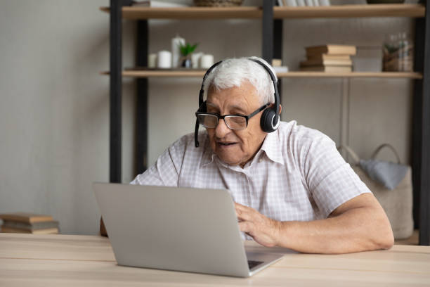 istock Happy elderly male pensioner holding video call conversation. 1368666495