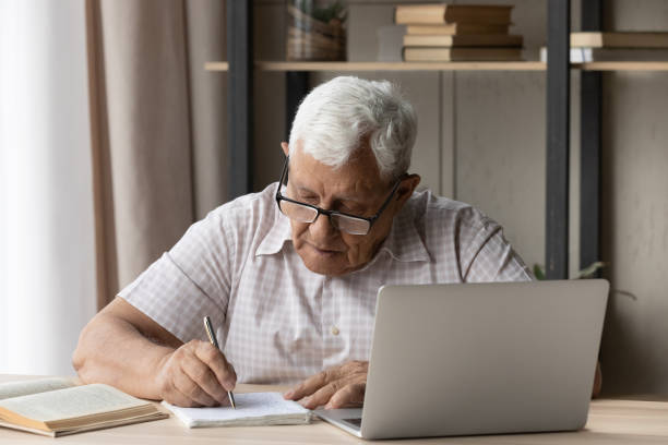 istock Concentrated old man studying on online courses. 1368666499