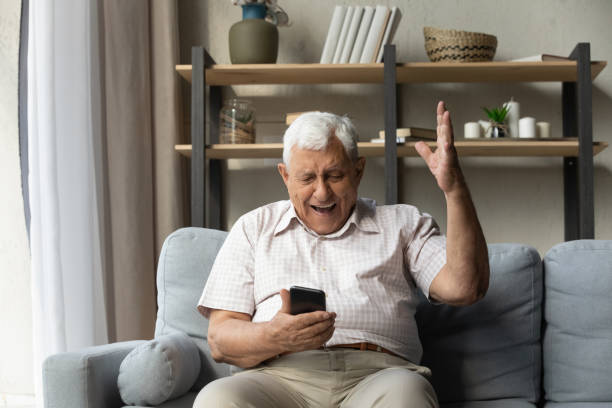 istock Overjoyed sincere old man celebrating internet success. 1368666507