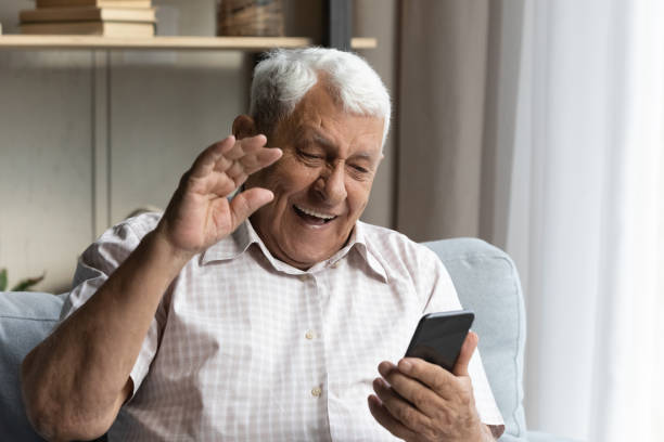 istock Happy senior man holding mobile video call meeting. 1368666508