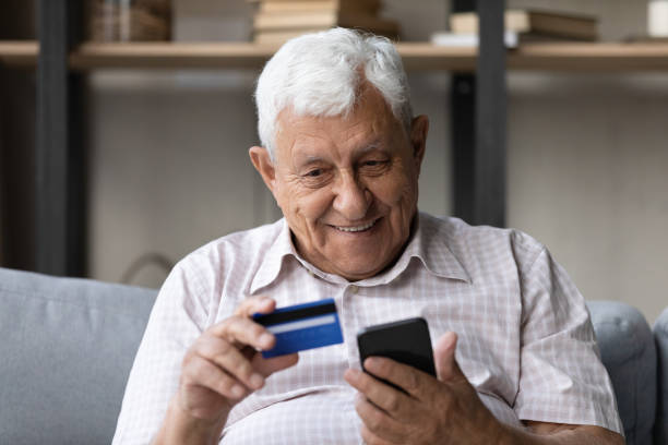 istock Happy older retired man shopping in mobile application. 1368666516
