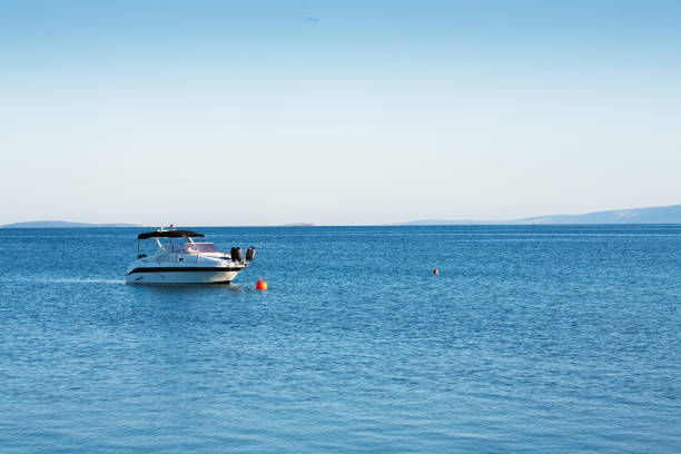 istock Small luxurious yacht moored at sea 1368668482