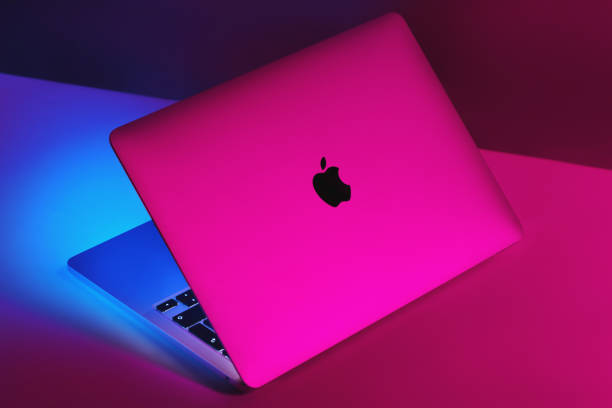apple brand m1 model macbook pro with colorful light background. - macbook apple macintosh laptop apple computers imagens e fotografias de stock