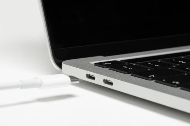 Close up shot of usb c cable plugging to a laptop computer