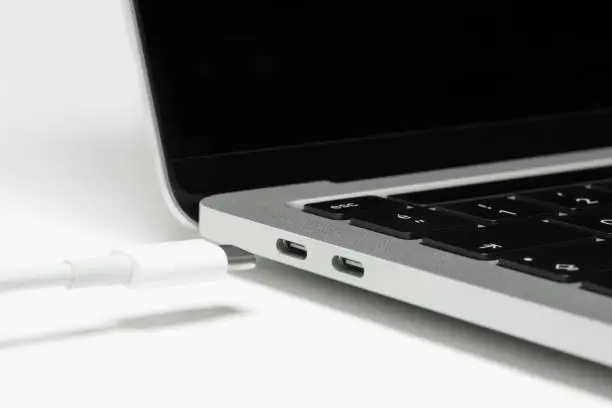 Photo of Close up shot of usb c cable plugging to a laptop computer