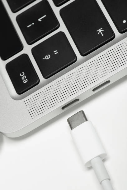 istock Close up shot of usb c cable plugging to a laptop computer 1368670506