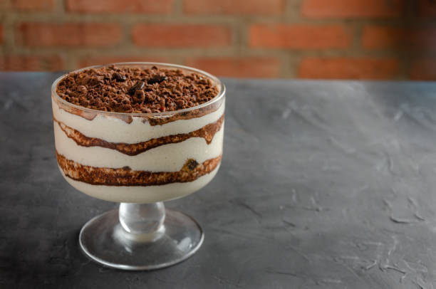 istock Tiramisu dessert served in glasses. Black brick wall background. 1368670559