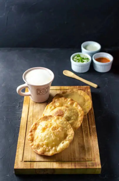 Pastelito traditional venezuelan food in dark backgroud, three sauce and coffee