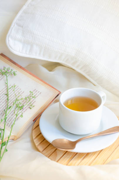 istock Tea cup next to book and leaves. Relax moment. 1368672516