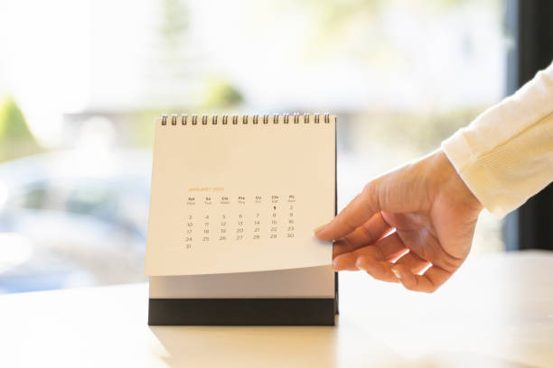 Close up of a 2022 monthly calendar with metal spiral-bound, standing on the table stock photo