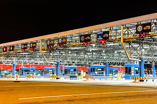 European Union border crossing seen during the night time with all the signs for customs and immigration entry and exits.