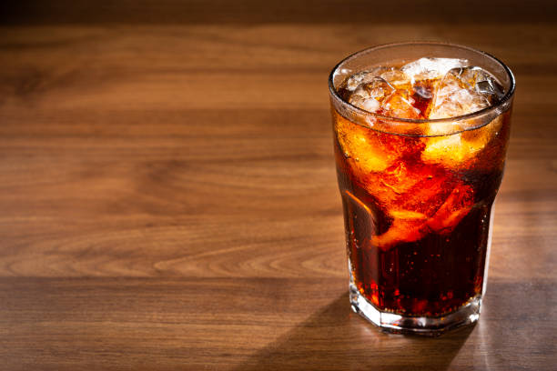 istock Soda glass with ice cubes on wooden table. 1368678665
