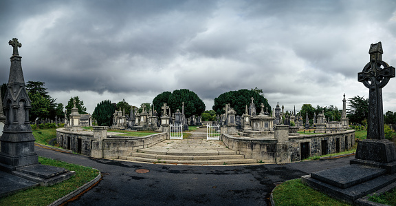 Dublin, Ireland, August 2019 Round mausoleum, cripts, ancient graves and tombstones with Celtic crosses in Glasnevin Cemetery