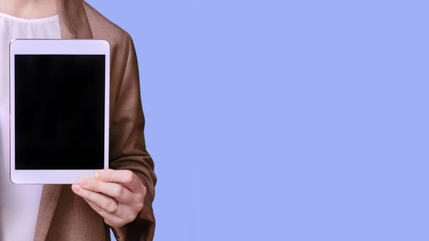 istock Woman teacher with tablet for online lesson on studio blue background, banner copy space 1368680826