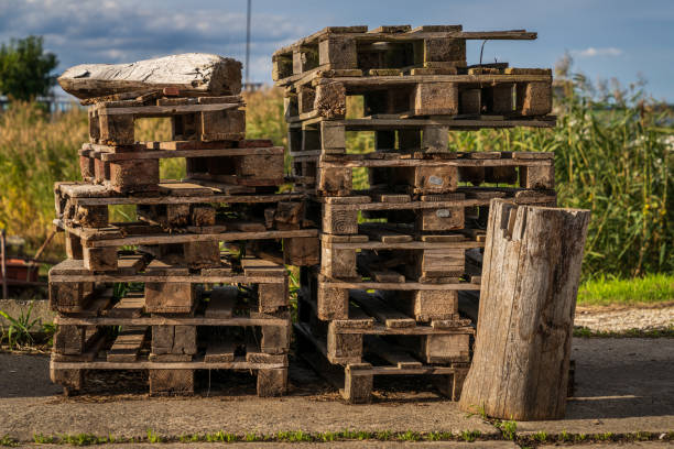 Closeup of a stack of Euro Pallets with a field in the blurry background