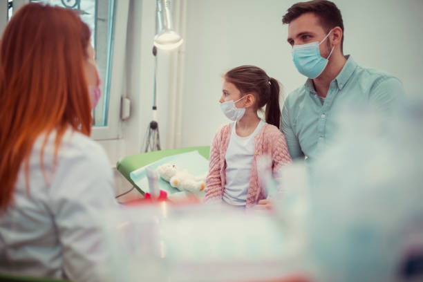 istock Father and daughter at a systematic examination by a doctor. 1368681007