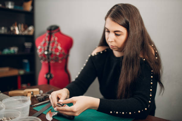 istock Tanner woman making leather goods on workshop. Working process of leather craftsman 1368681114