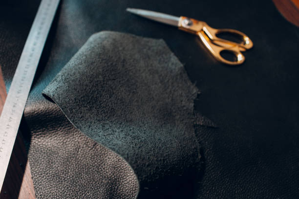 istock Tanner woman making leather goods on workshop. Working process of leather craftsman 1368681116