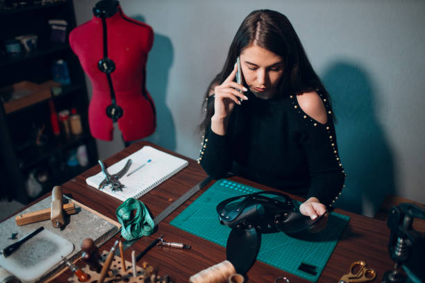 istock Tanner woman making leather goods on workshop. Working process of leather craftsman 1368681133