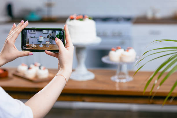 istock Pastry chef confectioner young caucasian woman with cake on kitchen table. 1368681149