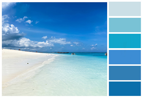 A blue palette created from a beautiful landscape with azure water and white sand.