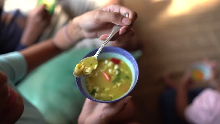 Girl eating soup at home